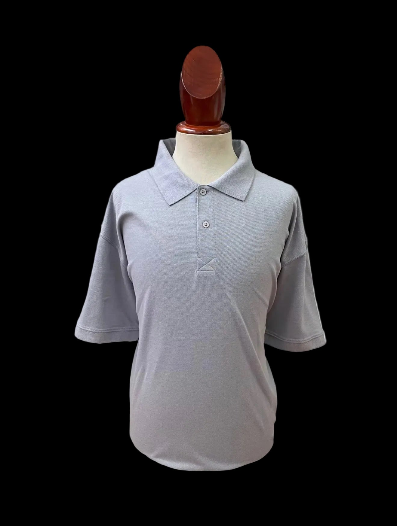 Gray polo shirt blank on a mannequin against a light gray background