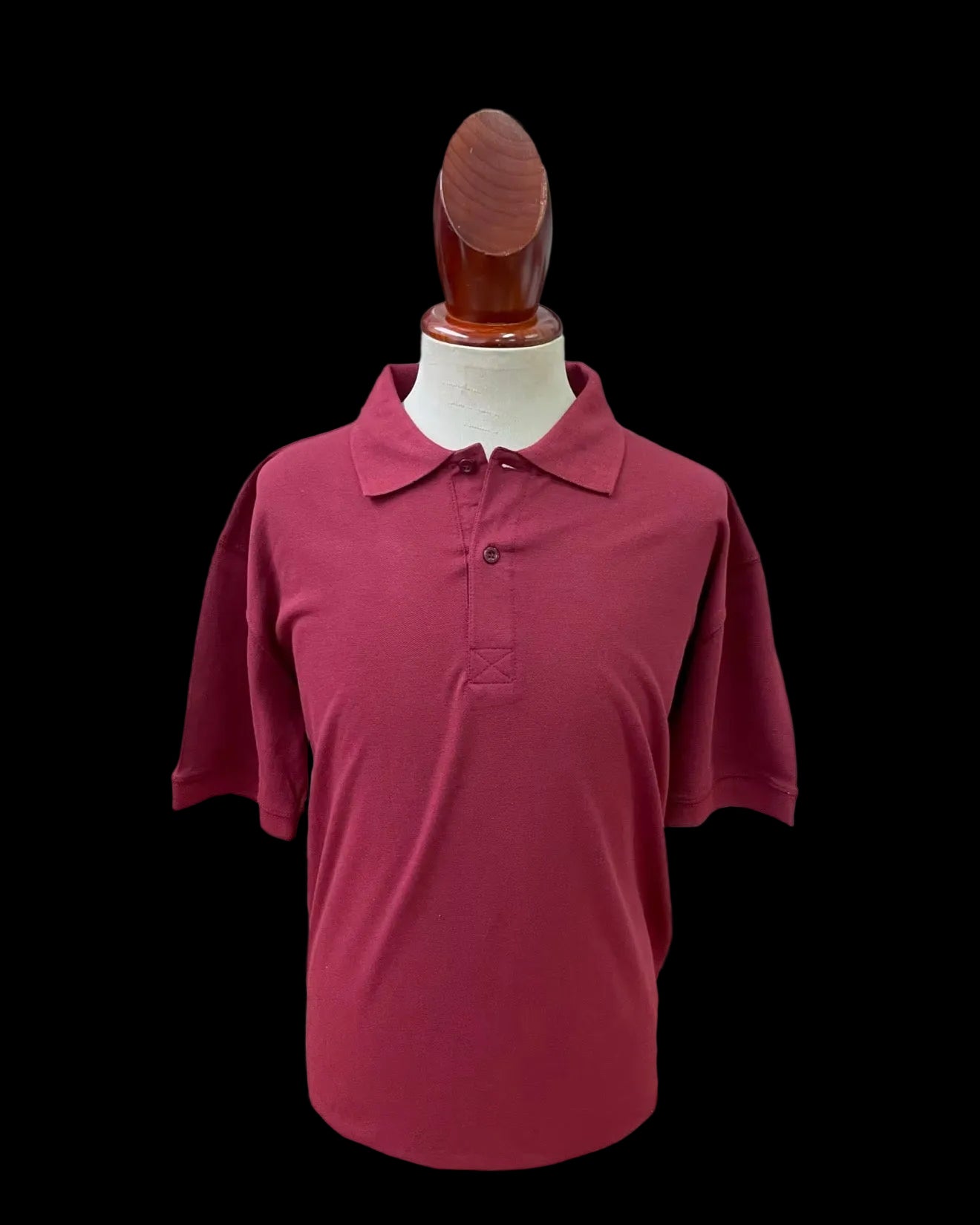 Burgundy polo shirt blank on a mannequin against a light gray background
