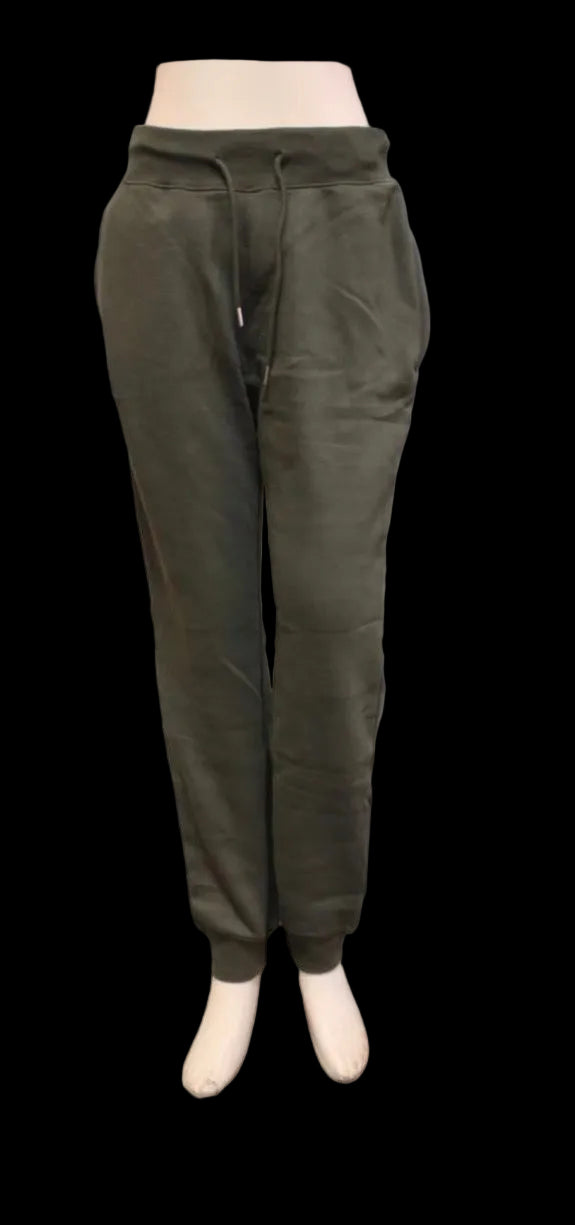 Green sweatpants on a mannequin against a white background