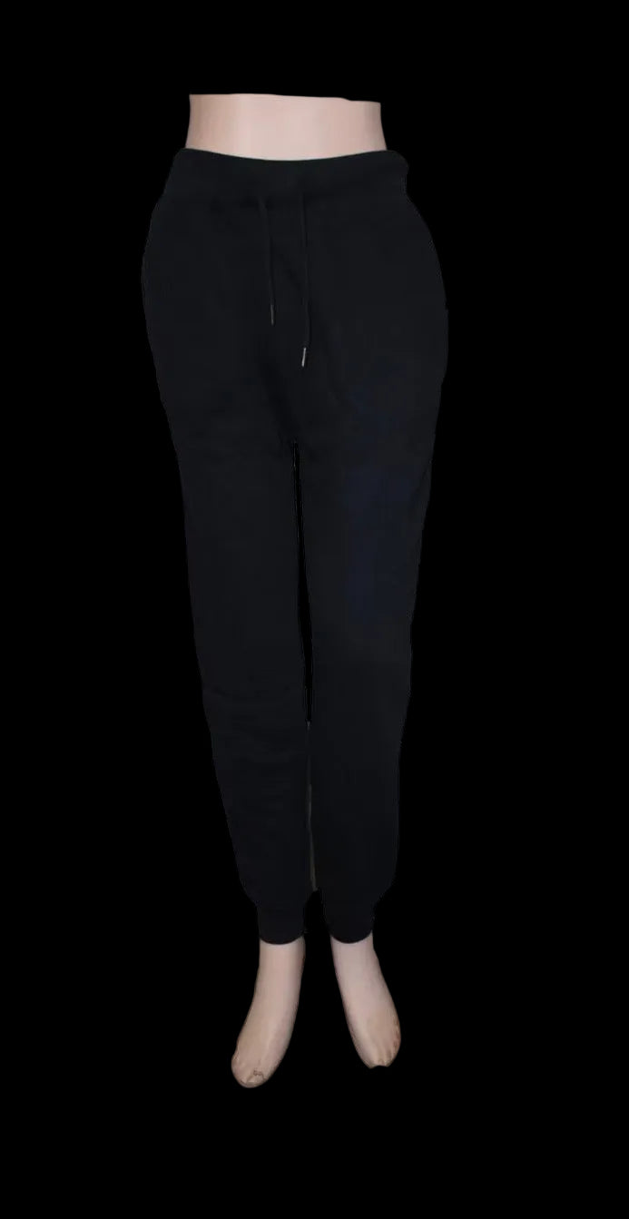 Black sweatpants on a mannequin against a white background