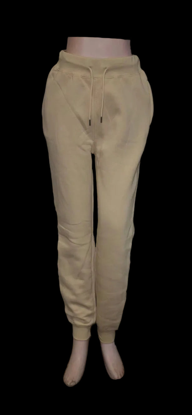 Beige sweatpants on a mannequin against a white background