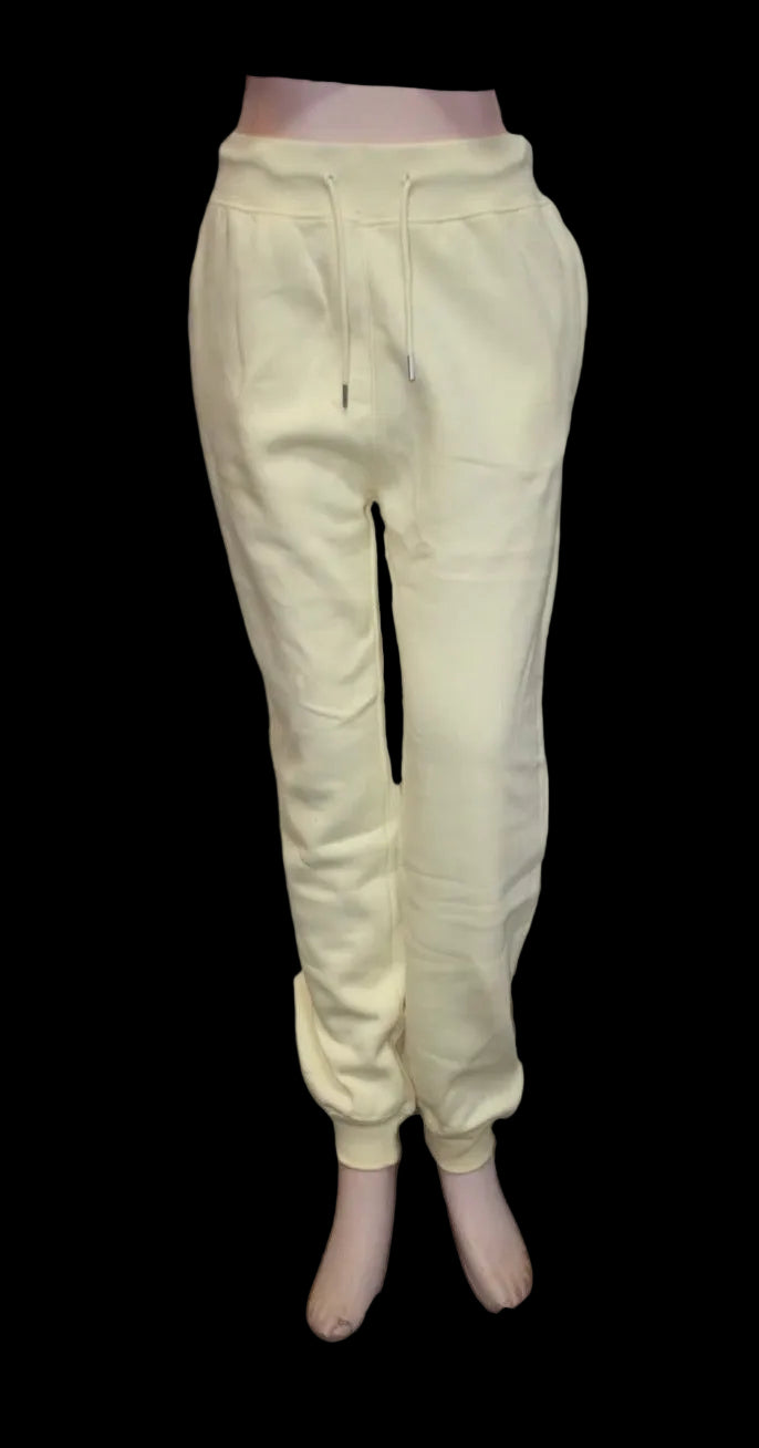 Light yellow sweatpants on a white background
