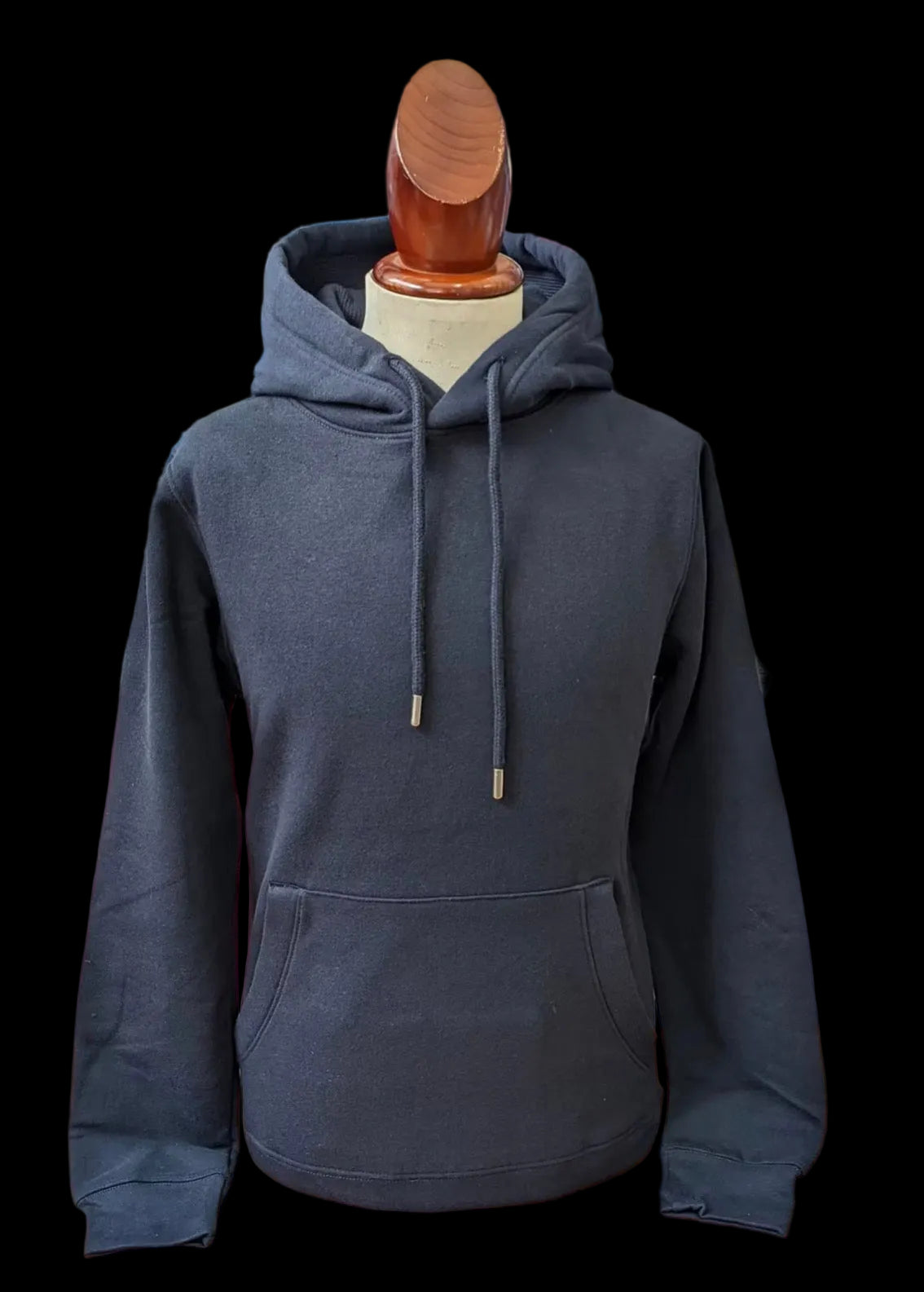Dark gray hoodie on a mannequin with a blurred background of other clothing items.